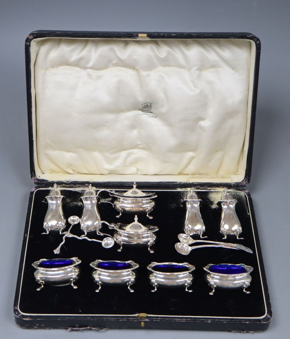 A George V cased ten piece silver condiment set, Adied Bros, Birmingham, 1925 and four associated condiment spoons.